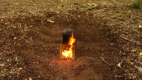 Boiling Water and Coffee over Wood Stove Campfire. Cup of Water Boiling Stock Footage 306533019