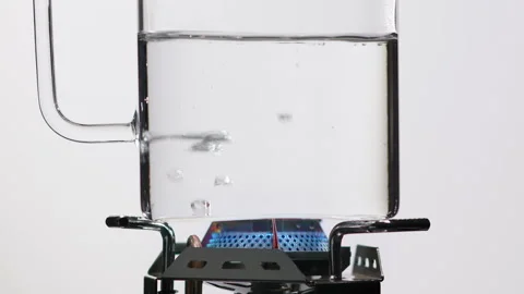 Boiling Water and refraction in a transparent vessel on fire. Blue flame Stock Footage 144453553