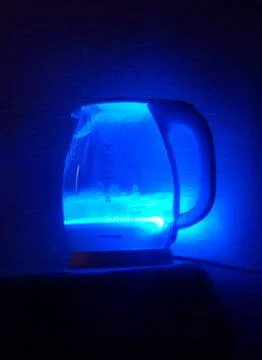 Boiling water in a blue light in the dark Stock Photos