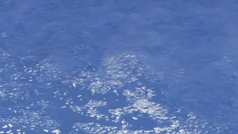 Boiling water. Bubbles and foam on a blue background. Stockbeeldmateriaal 136696645