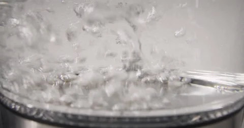 Boiling water with bubbles at the bottom of the electric kettle, slow motion Stock Footage 237185340