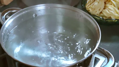 Boiling water bubbling in a pot. Slow motion video 100fps. Stock Footage 308084550
