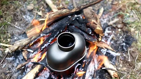 Boiling water on a campfire Stock Footage 154770259