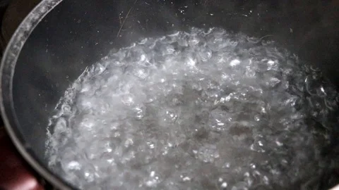 Boiling water in casserole Stock Footage 128569071