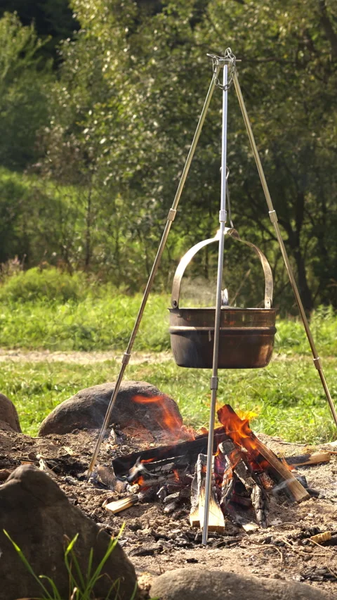 Boiling water in a cauldron over a fire.  Vertical video. Stock Footage 277116440