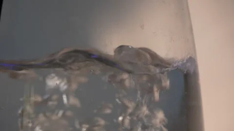 Boiling water close-up inside glass kettle with rising bubbles Stock Footage 312278812