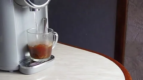 Boiling water from the cooler is poured into a mug of coffee Stock Footage 170792192