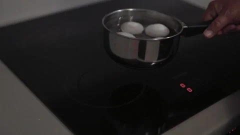 Boiling water with eggs in a kitchen. Stock Footage 311806113