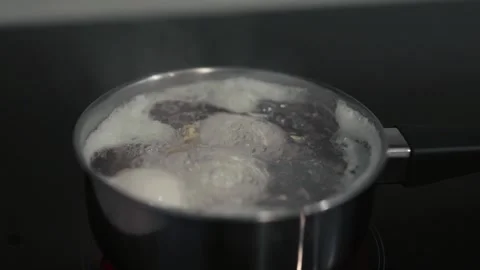 Boiling water with eggs in a kitchen.	 Stock Footage 311806429