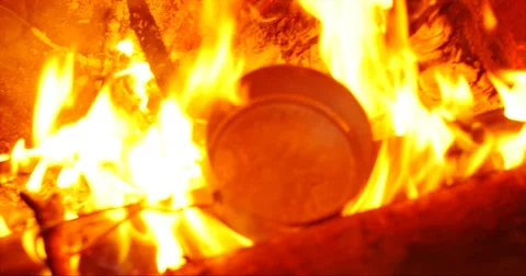 Boiling water on fire bonfire campside. boiling kettle on the fire Stock Footage 58062547