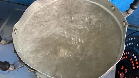 Boiling water heating in pot at kitchen. POV shot. Stock Footage 312133541