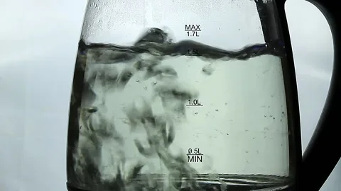 Boiling water inside a glass teapot Stock Footage 151378408