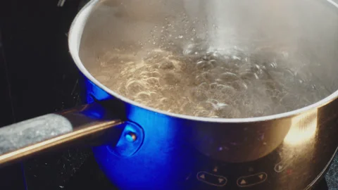 Boiling water in kitchen, cooking, preparing a cake. Stock Footage 149122354