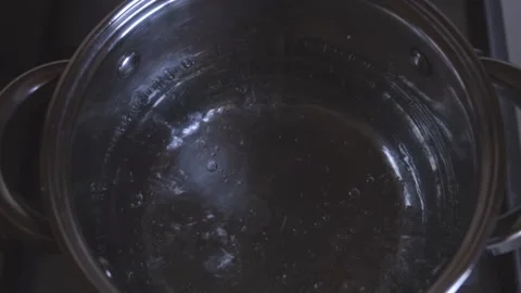 Boiling water in metallic saucepan close-up Stock Footage 251763724