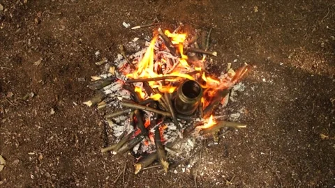 Boiling Water over the Campfire. Boiling Water in Metal Bottle for Survival Stock Footage 306871377
