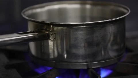 Boiling water on a pan in burner Stock-Footage 133207033