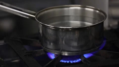 Boiling water on a pan in burner Stock-Footage 133207042