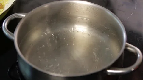 Boiling water in pan Stock Footage 77046418