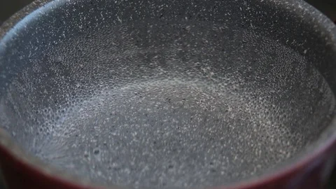 Boiling water in pan in kitchen, hot water with bubbles 1 Stock Footage 129822156