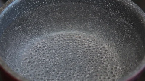 Boiling water in pan in kitchen, hot water with bubbles 2 Stock Footage 129822189
