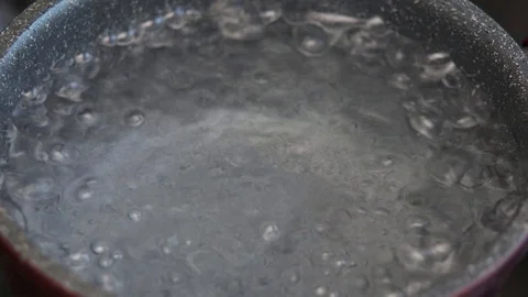 Boiling water in pan in kitchen, hot water with bubbles 4 Stock Footage 129822244