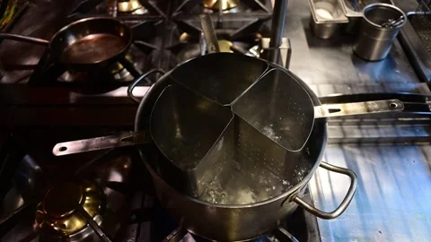Boiling water in pasta cooker on commercial stove Stock Footage 327581853