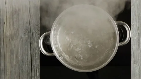 Boiling water in a pot. Boiling point. View from above. Stock Footage 147870419