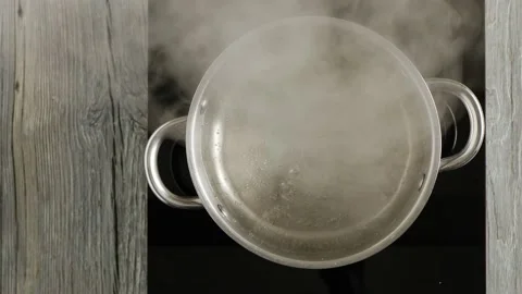 Boiling water in a pot. Boiling point. View from above. Stock Footage 147870453