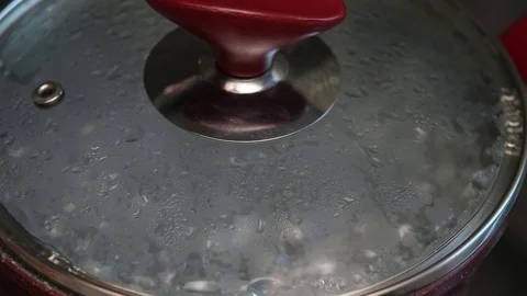 Boiling water in a pot with a cap Stock Footage 129090345