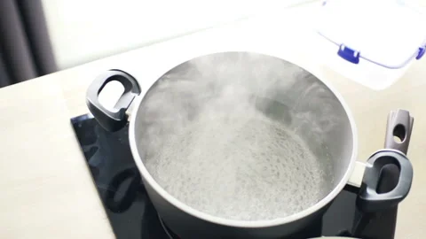 Boiling water in pot in kitchen slow motion Stock Footage 87293623