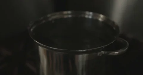 Boiling water in a pot for soup Stock Footage 76413212