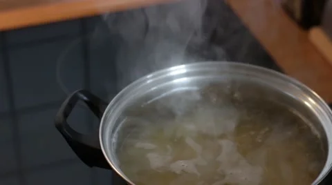 Boiling Water in a pot on a stove Stock Footage 49655320