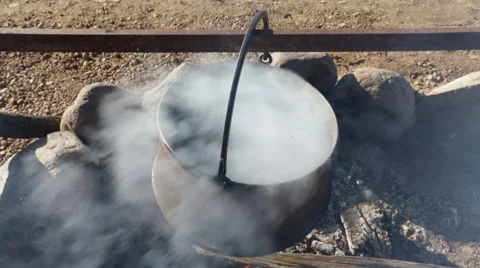 Boiling water in a pots above the fire. Video stock 56481379