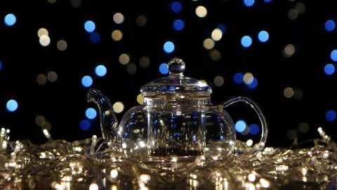 Boiling water pour in teapot with tea leaves. Flickering lights Stock Footage 73631190