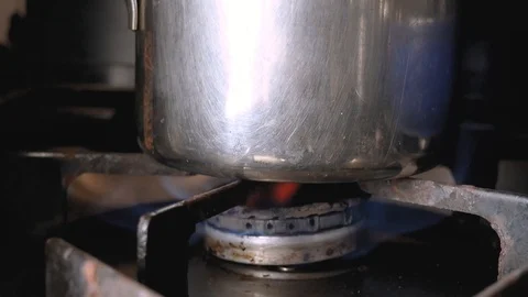 Boiling water, on a rusty the stove, to make a nice cup of Stock Footage 125780069