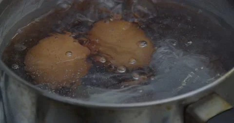 Boiling water in a saucepan with eggs Stock Footage 237883638