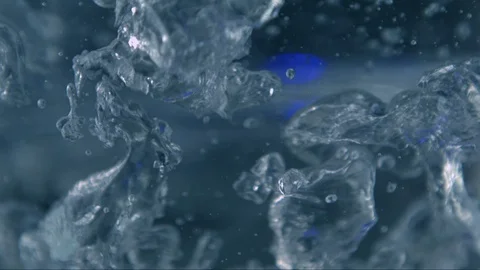 Boiling water in slow motion with blue light flashing in background - high speed 스톡 동영상 100878423