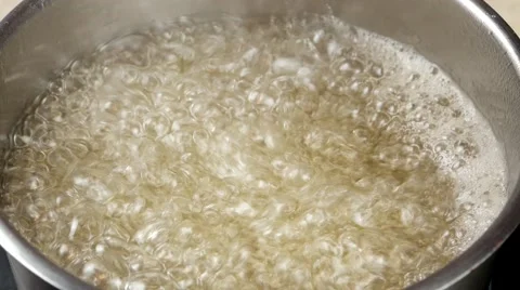 Boiling water with sugar in a pot, bubbling over Stock Footage 62425526