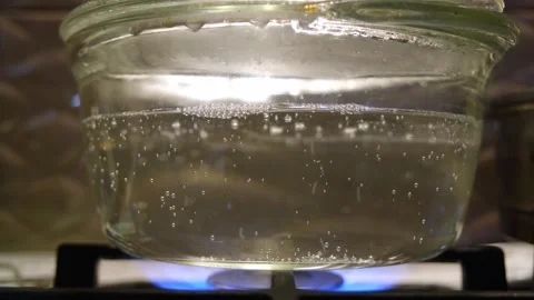 Boiling water in a transparent pan. The process of boiling water slow motion. Wa Stock Footage 283412031