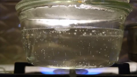 Boiling water in a transparent pan. The process of boiling water slow motion Stock Footage 283815796