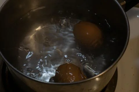Boiling Water with Two Eggs Stock Photos