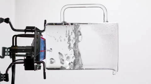 Boiling Water vertical video. Liquid Boils in a Transparent container. Stock Footage 144459686