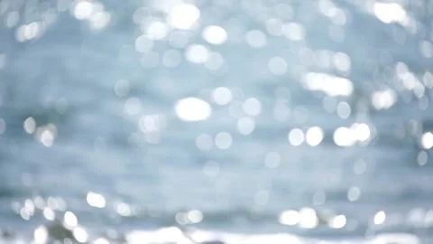 Bokeh abstract sea background of a summer ocean sunset with small waves on the Stock Footage 252345803