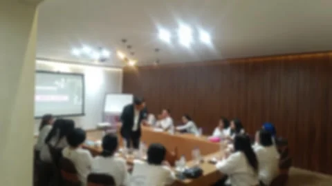 Bokeh background of A lecture presentation in a conference room, with a speaker Stock Footage 340533766