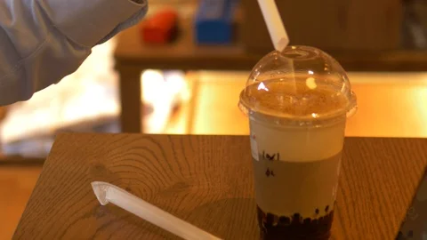 Bokeh background stirring bubble tea coffee drink Stock Footage 122666880