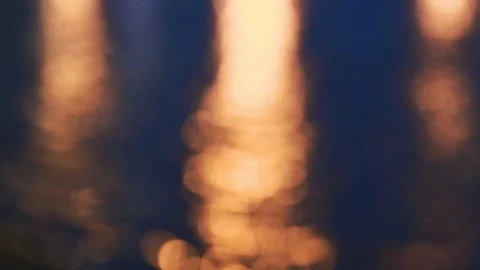 Bokeh background from a water pond on a windy night with light reflection Stock-Footage 107432469