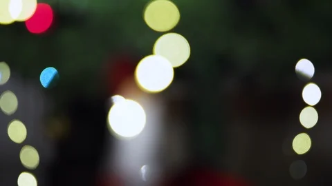 Bokeh blurred  christmas tree background, rack focus to Santa Clause miniature. Stock Footage 121719482