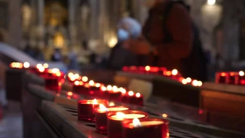 Bokeh of burning candles at church while people pray. Stock Footage 305458747