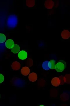 Bokeh of colored round festive Christmas lights. Stock Photos
