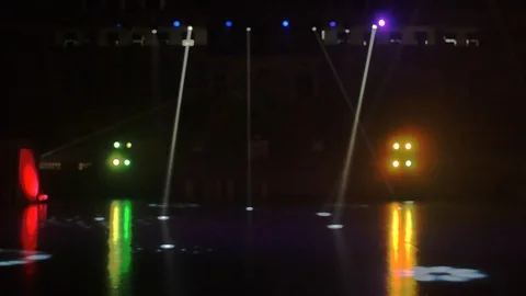 Bokeh of dark stadium being light by RGB spotlight during event Stock Footage 113132540
